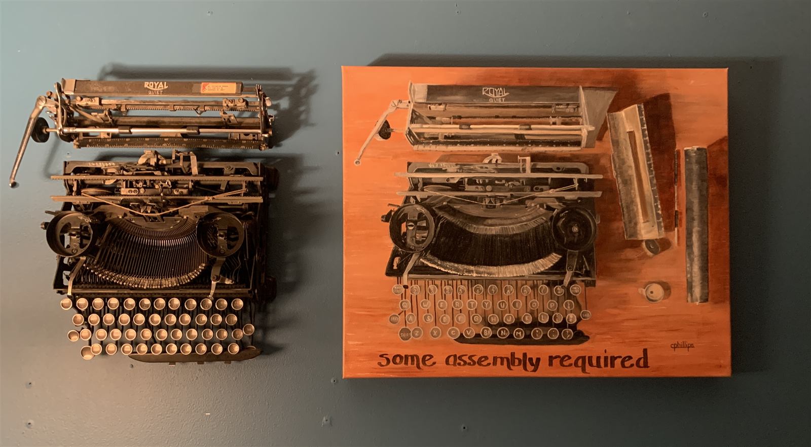 A real disassembled Royal typewriter hanging on the wall beside a painting of the same machine, captioned &lsquo;some assembly required.&rsquo;